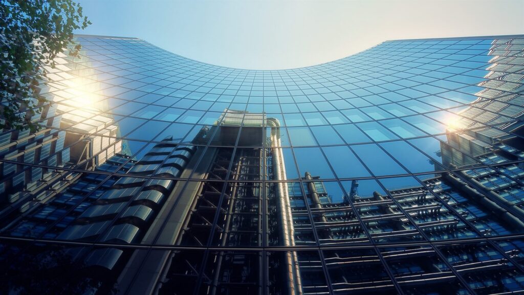 Glass office tower reflecting the sky