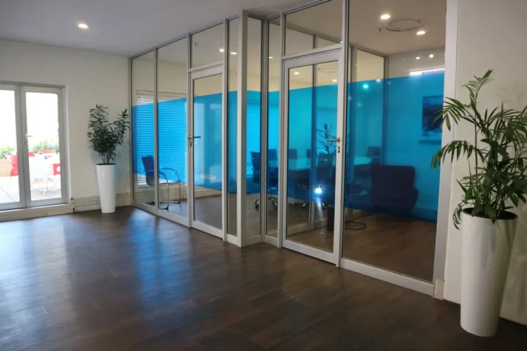 Glass-partitioned offices with blue privacy film